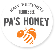 A white button with the words " pa 's honey " on it.